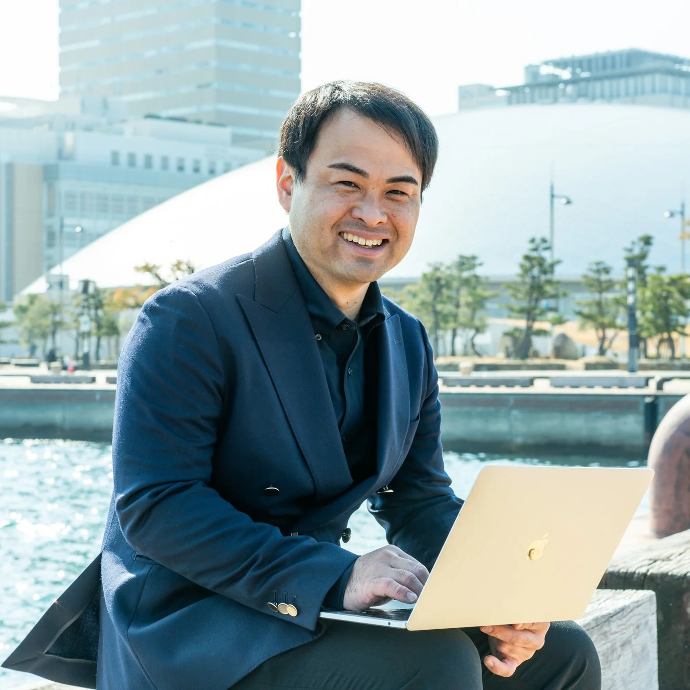水辺でノートパソコンを使う植田代表