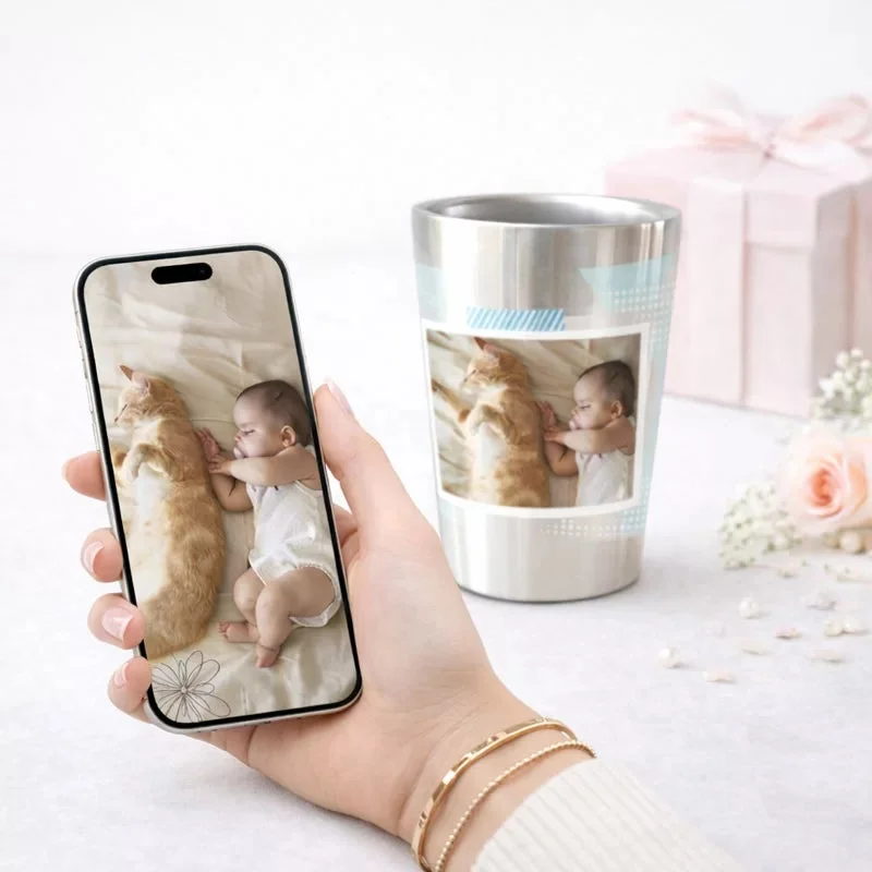 スマートフォンで写真を見つめる女性とマグカップ